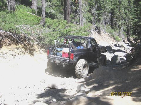 1994 Ford Bronco - Off-roading in a modified 1994 Ford Bronco on a challenging rocky path.