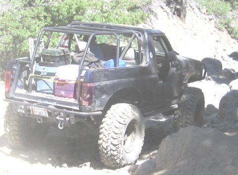 1994 Ford Bronco - This modified SUV is equipped for off-road adventures, carrying gear in its open rear.