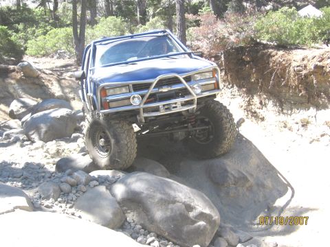 1994 Ford Bronco - A modified blue truck tackles a challenging rocky trail on July 19, 2007.