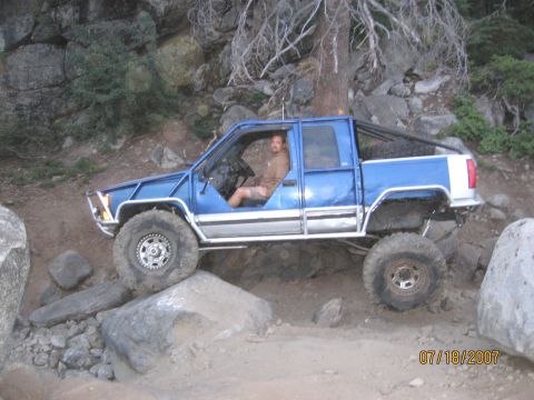 1994 Ford Bronco - A man drives a modified blue pickup truck over a rocky trail on 07/18/2007.