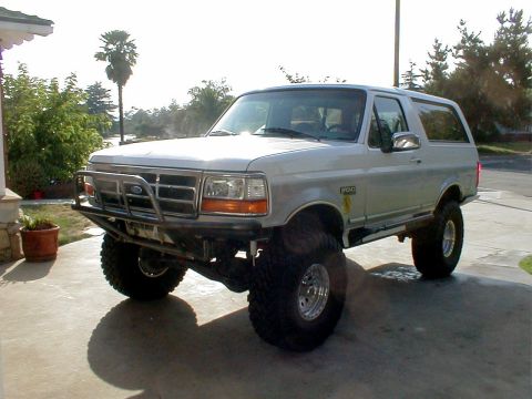 1996 Ford Bronco - Silver 1996 Ford Bronco parked on a driveway, a custom bumper and large off-road tires.
