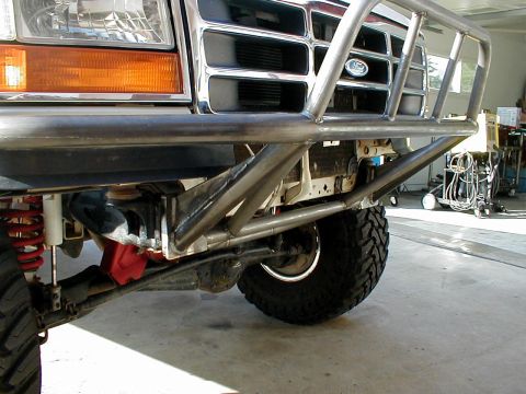 1996 Ford Bronco - Custom front bumper installed on a 1996 Ford Bronco, showing off-road suspension and tires.