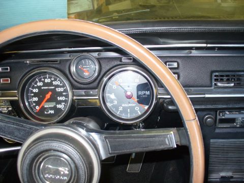 1968 Mercury Cougar - Dashboard of a 1968 Mercury Cougar, aftermarket Auto Meter gauges and a wood-rimmed steering wheel.