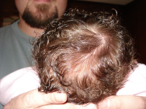 2000 Ford Crown Victoria - A person holds a baby's head, showing curly brown hair.