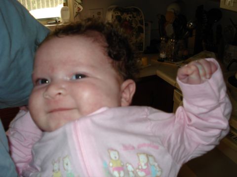 2000 Ford Crown Victoria - A baby wearing pink pajamas with cartoon animals is shown in a close-up shot.
