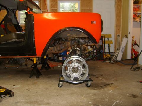 1994 Ford Bronco - Vehicle body undergoing repairs in a garage, engine components visible.