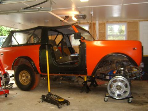 1994 Ford Bronco - This vehicle is undergoing repairs in a garage, with its doors and top removed.