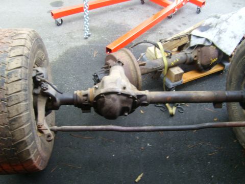 1994 Ford Bronco - Close-up of a vehicle's rear axle assembly, showing the differential, brake components, and a tire.