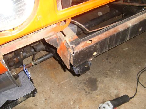 1994 Ford Bronco - The image shows a close-up view of a vehicle's frame and suspension system, with a portion of the headlight visible.