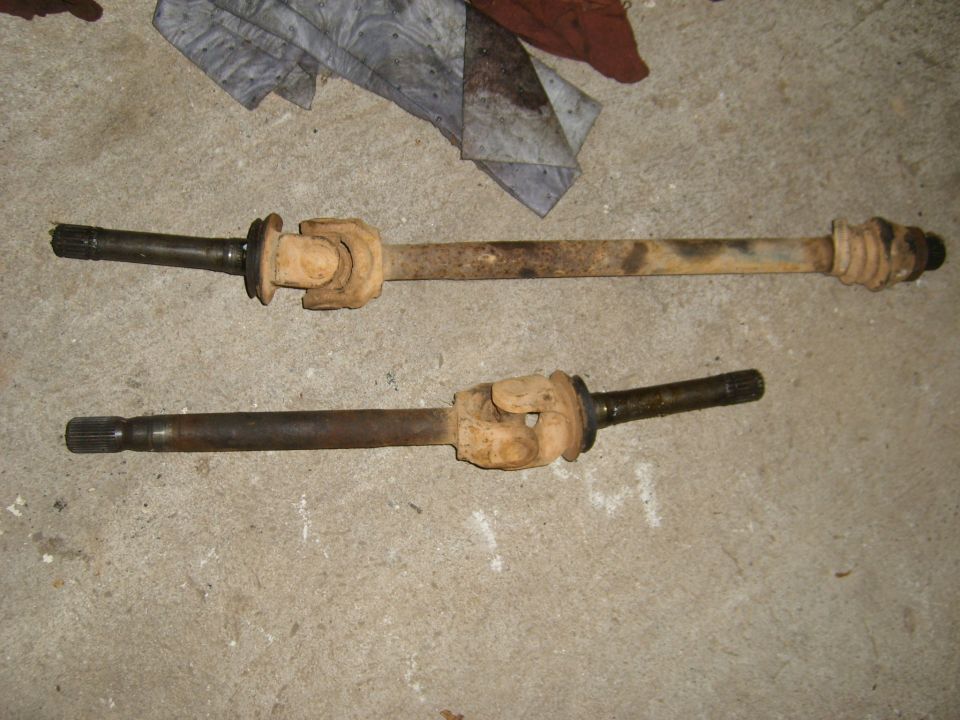 Two driveshafts with universal joints on a concrete floor
