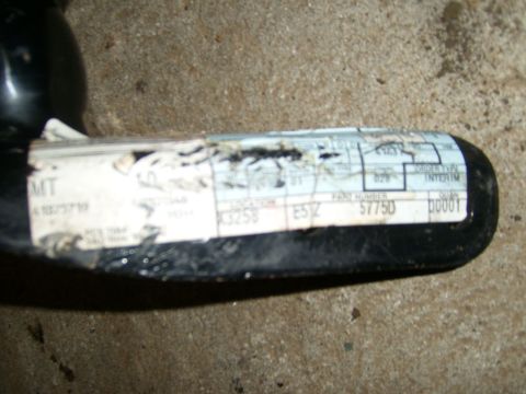 1994 Ford Bronco - A close-up of a vehicle part displays a label with various codes and the part number 57750.
