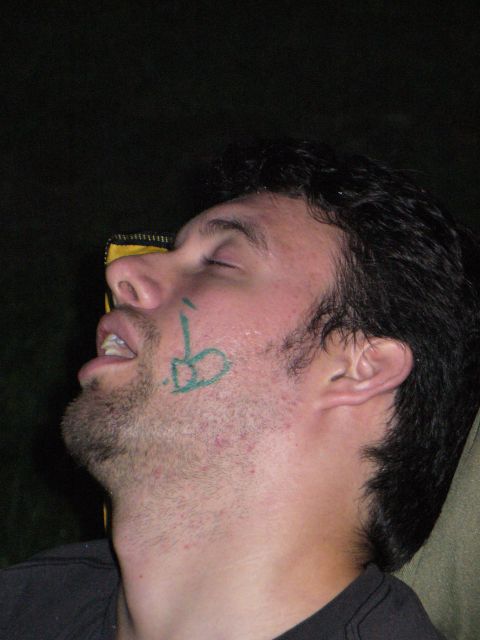 1991 Ford Probe - Man with green drawing on his face appears to be asleep.