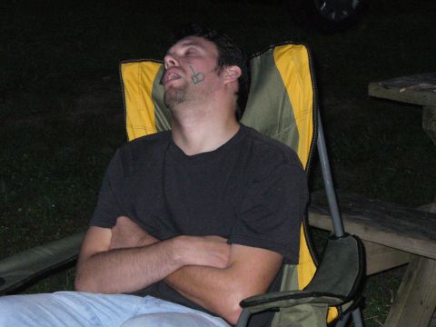 1991 Ford Probe - A man appears to be sleeping soundly in a camping chair outdoors.