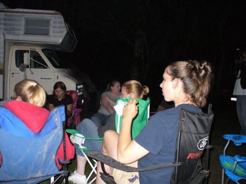 1991 Ford Probe - Campfire gathering with an RV in the background.