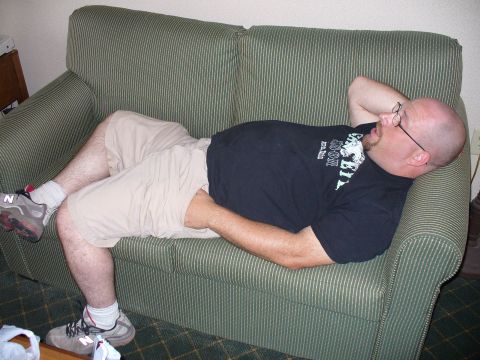 1991 Ford Probe - A man rests on a green striped couch, with his hand behind his head.