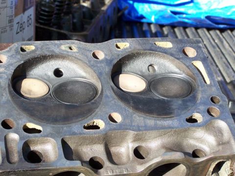 1979 Ford Bronco - This is a close-up view of an engine cylinder head, showing the valve ports and surrounding metalwork.