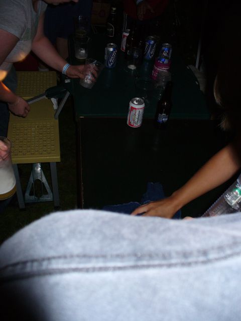 1991 Ford Probe - A group of people are socializing around a table with drinks, with a focus on the beverages and hands.