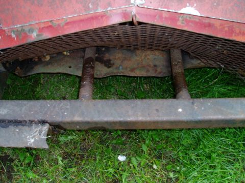 2000 Ford E350 - Close-up of rusted metal components and green grass.