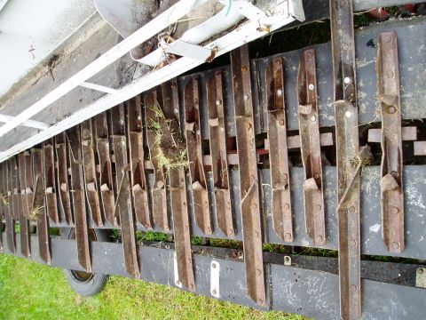 2000 Ford E350 - A close-up view of a trailer's attachment, showing numerous metal tines and a portion of a wheel.