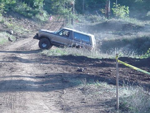 1989 Ford Bronco - Ken coming out of a mud hole on the big tire side