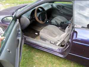 1996 Ford Probe - Interior view of a purple car, cloth seats and a visible SuperMotors watermark on the door.