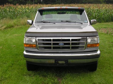 1994 Ford Probe - This 1995 Ford F-150 truck is shown from the front, with a cornfield behind it.