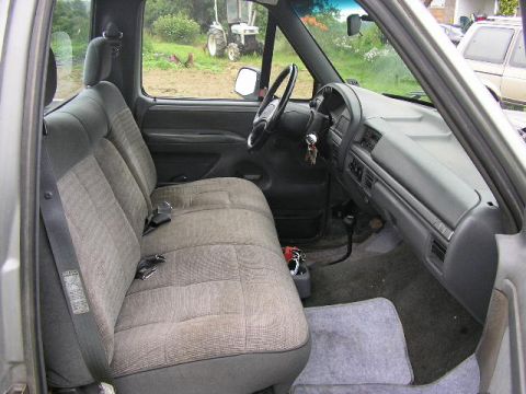 1994 Ford Probe - Interior view of a 1994 Ford F-150 pickup truck, showing the bench seat, dashboard, and steering wheel.