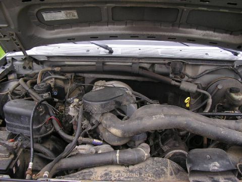 1994 Ford Probe - The engine bay of a vehicle is shown with various mechanical parts and hoses.