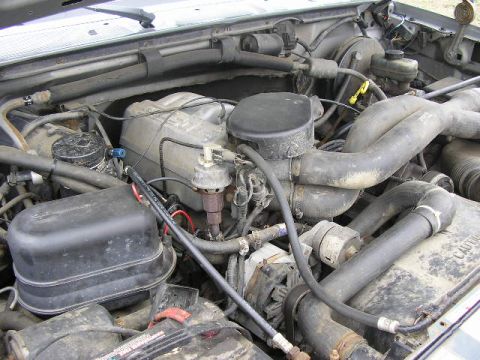 1994 Ford Probe - Close-up view of a vehicle's engine bay, showing various components and hoses.