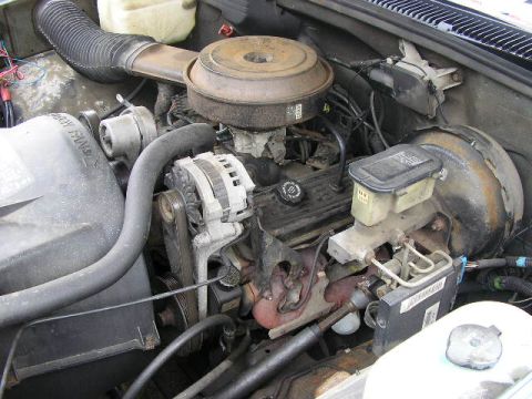 1994 Ford Probe - The engine bay of a vehicle shows a V8 engine with various components.