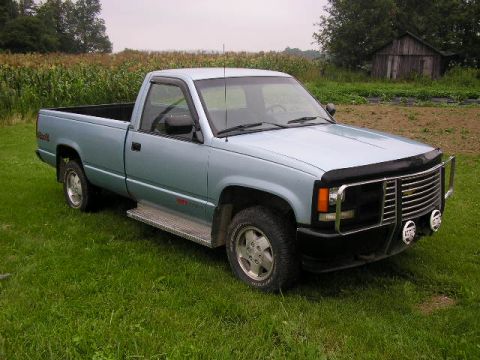 1994 Ford Probe - This light blue pickup truck, likely a 1994 model, is shown in a three-quarter front view, a prominent chrome grille and a protective bull…