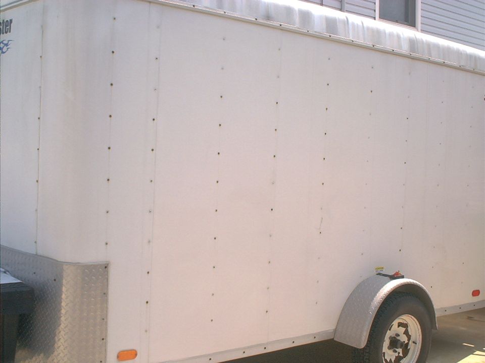 White cargo trailer side with diamond plate corner and fender