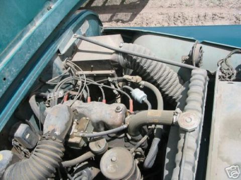 2000 Ford E350 - Close-up view of an older vehicle's engine compartment, showing various mechanical components.