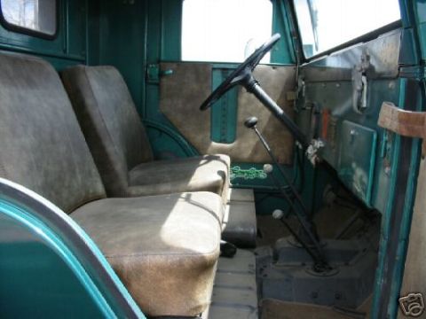 2000 Ford E350 - Interior of an old truck with two seats and a manual transmission.