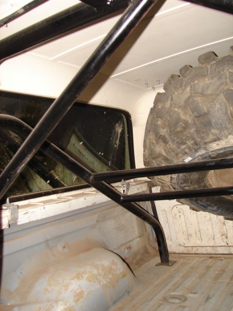 1996 Ford Bronco - The interior of the vehicle features a roll cage and a spare tire, suggesting off-road modifications.
