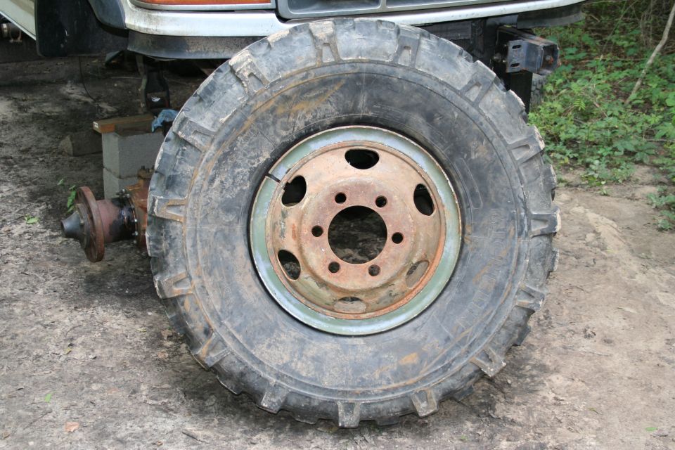 Mounted on the M35 split rims. These will do for trail use until I can get something else worked out... Like some double beadlocks. ($$$)

Mounting technique was pretty redneck. I used a Kubota w/ pallet forks to smash the tire down then began inserting the split rim piece, and then used some 1/2x1" flat stock as a safety bar through the rim to prevent the split piece from coming off while mounting the rest. It actually worked really well, mounted in under 15 minutes, and the safety bar does actually work.