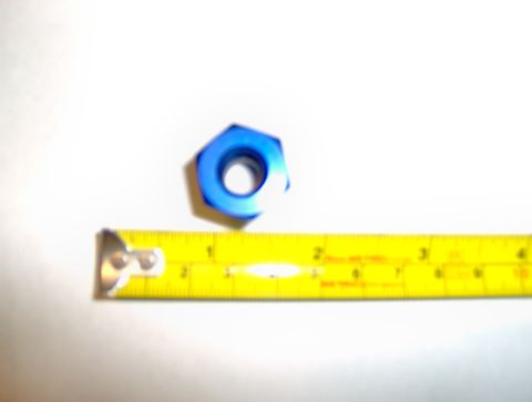 1978 Ford Bronco - A blue hex nut is shown next to a tape measure for scale.