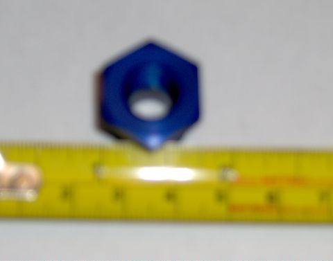 1978 Ford Bronco - A blue hexagonal nut is shown next to a yellow ruler for scale.