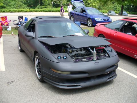 1991 Ford Probe - A matte gray 1993 Ford Probe is parked with its hood open, revealing the engine bay.