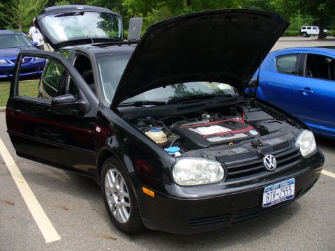 1991 Ford Probe - This black Volkswagen Golf has its hood and doors open, with a laptop placed on the roof.