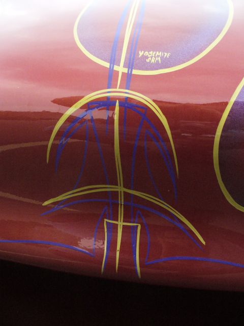 1991 Ford Probe - Custom pinstripe graphics adorn a red vehicle, including the text "Yosemite Sam".