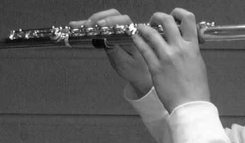 1990 Ford Bronco - Hands are shown playing a flute, with the instrument's keys visible.