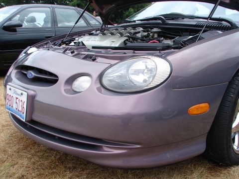 1993 Ford Taurus - Front view of a purple Ford Taurus with its hood open, revealing the engine compartment.