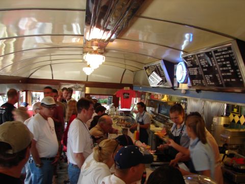 1993 Ford Taurus - A busy diner scene with customers waiting to order and staff preparing food.