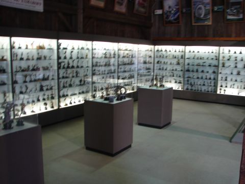 1993 Ford Taurus - Rows of illuminated display cases hold numerous small models in a museum setting.