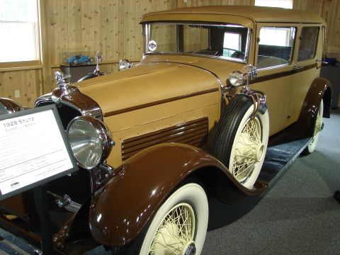 1993 Ford Taurus - A vintage Stutz sedan is displayed indoors with a descriptive plaque beside it.