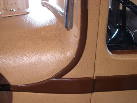 1993 Ford Taurus - Close-up of car interior trim showing textured panels and brown accent pieces.