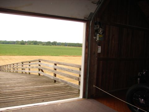 1993 Ford Taurus - Looking out from a garage onto a rural landscape with a wooden walkway.