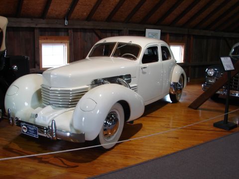 1993 Ford Taurus - A classic Cord sedan is displayed indoors, its unique design elements and vintage appeal.