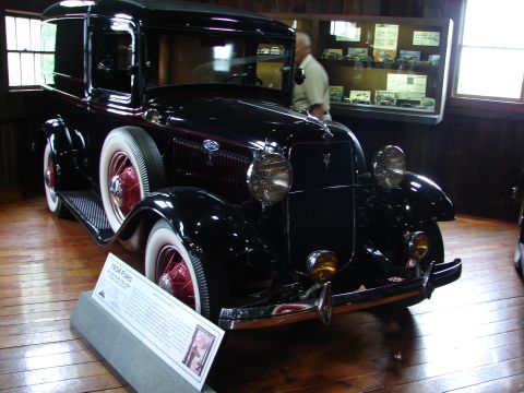 1993 Ford Taurus - This 1934 Ford truck is displayed indoors with a descriptive plaque in front of it.
